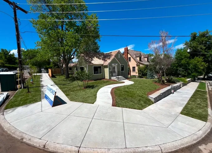 Beautiful Helena home with fresh sod, curved concrete driveway and pine trees