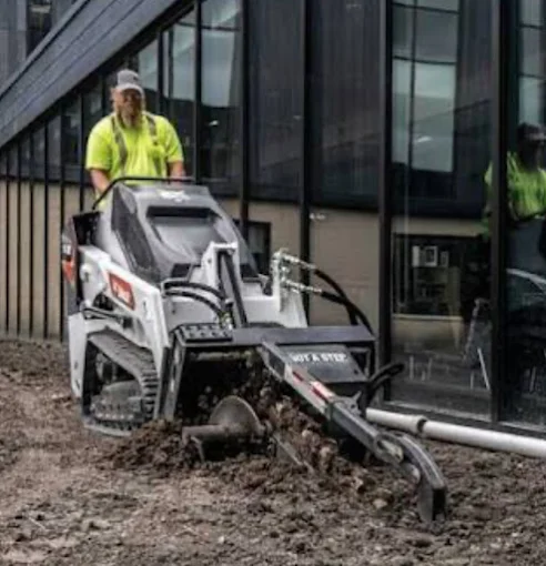 Bobcat MT120 mini track loader in a tight access backyard